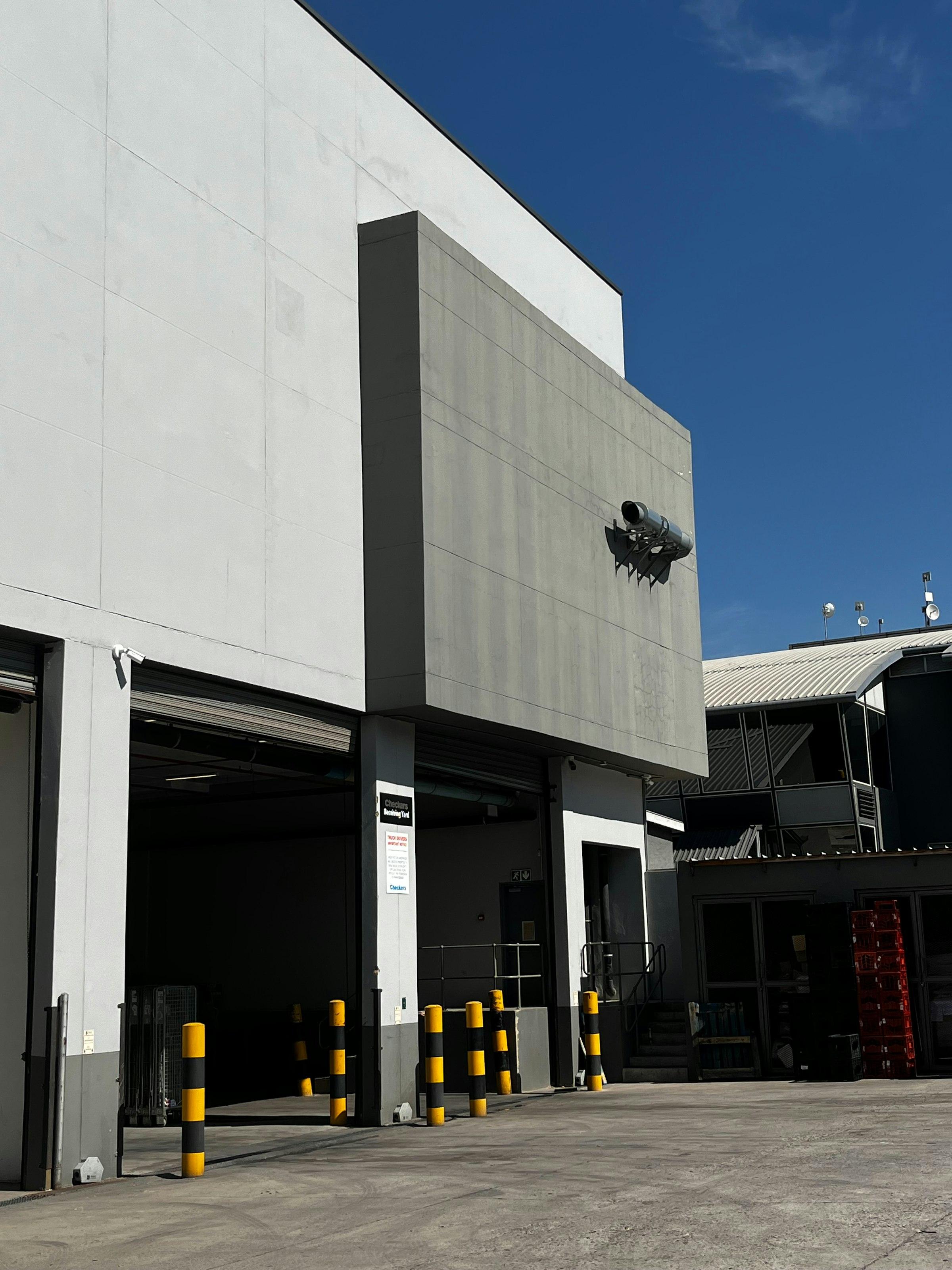 Modern commercial warehouse with visible security camera installation